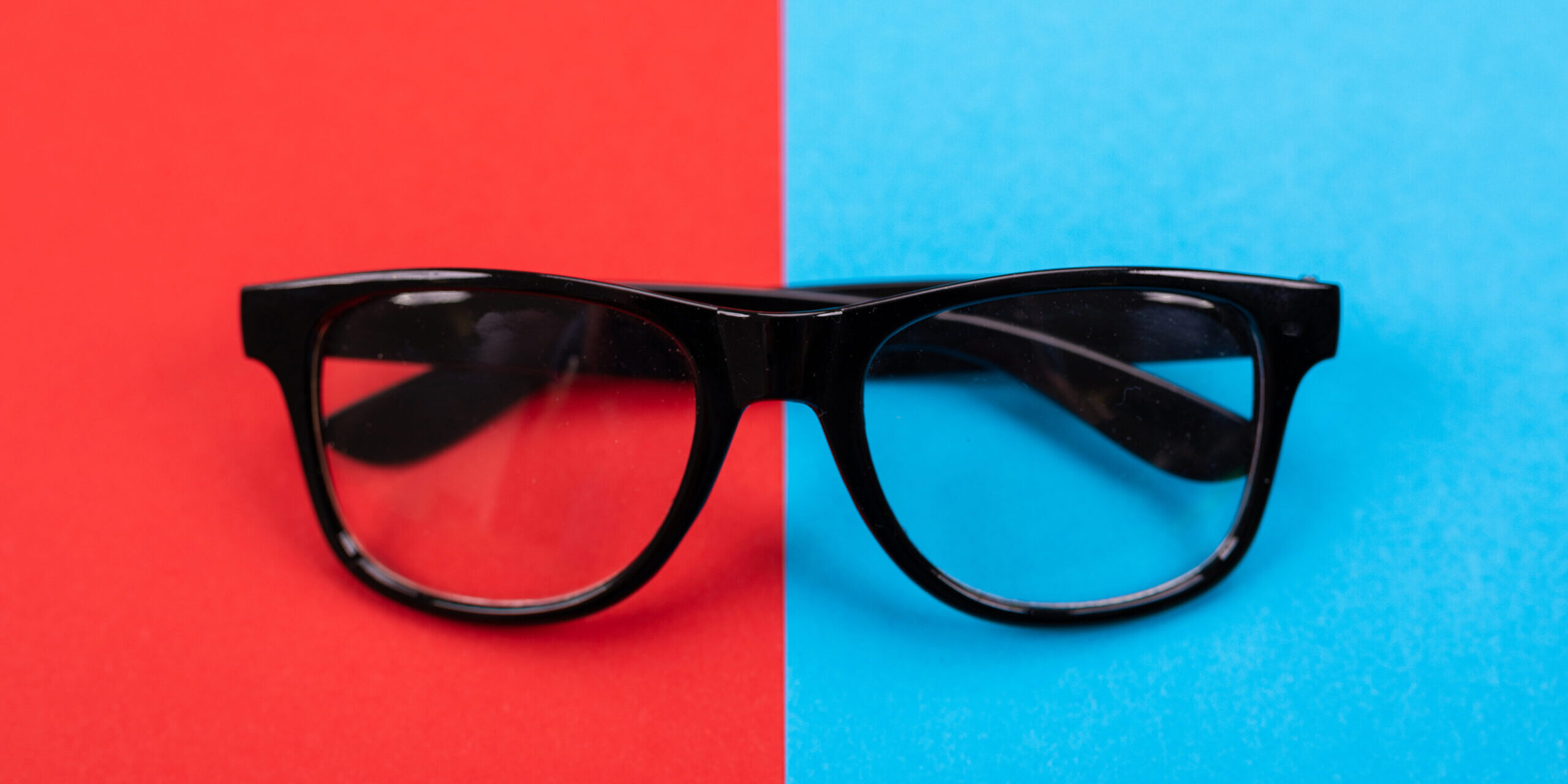 Glasses isolated on blue and red background